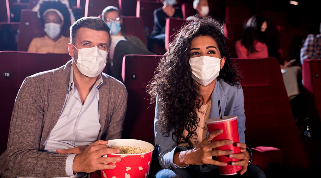 Masked man and woman at the movies 