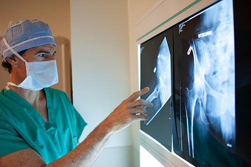 Orthopedic Surgeon William Leone examines an image