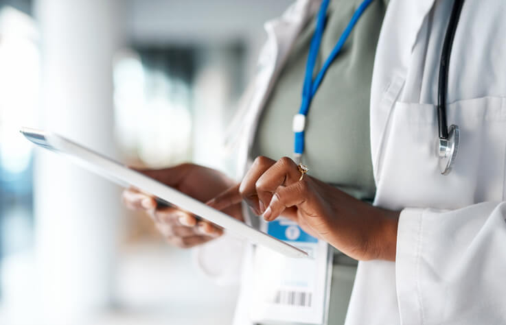 healthcare worker on tablet
