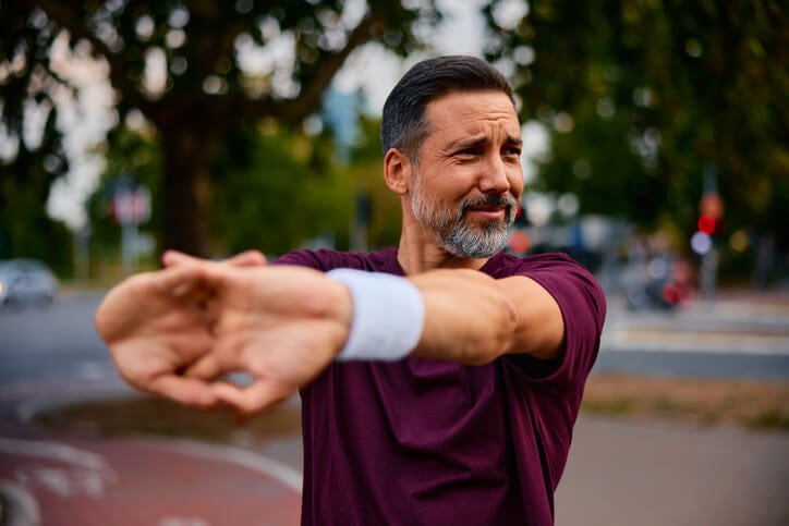 man stretching his shoulders