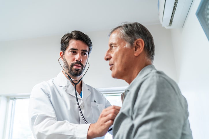 male doctor checking heart rate