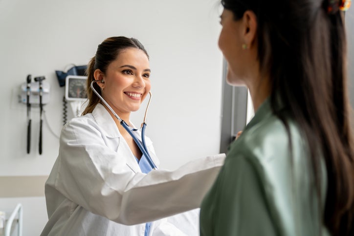 female doctor checking patient 