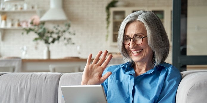 woman holding tablet and smiling 