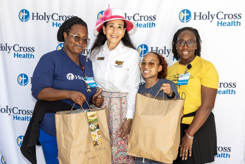 Rita Case with Holy Cross Health employees kicking off Hospital Week
