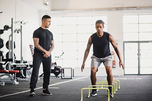 Man working out under supervision