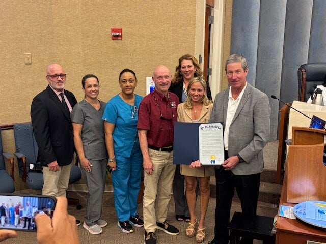 • (left to right) Scott Moore, Director of Parks & Recreation, City of Pompano Beach; Casey Dickenson, RN, Holy Cross Health; Sharon A. Walters, RN, Holy Cross Health; patient Brad Campbell, Senior Recreation Leader, City of Pompano Beach; Audrey Fesik, District 1 Commissioner, City of Pompano Beach; Alison Fournier, Vice Mayor, City of Pompano Beach; and Rex Harden, Mayor, City of Pompano Beach (Courtesy: Brad Campbell)
